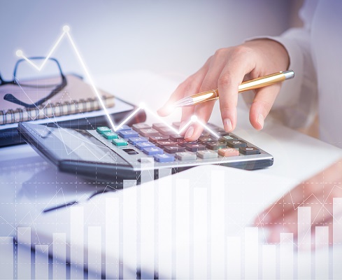 Accountant calculating profit with financial analysis graphs